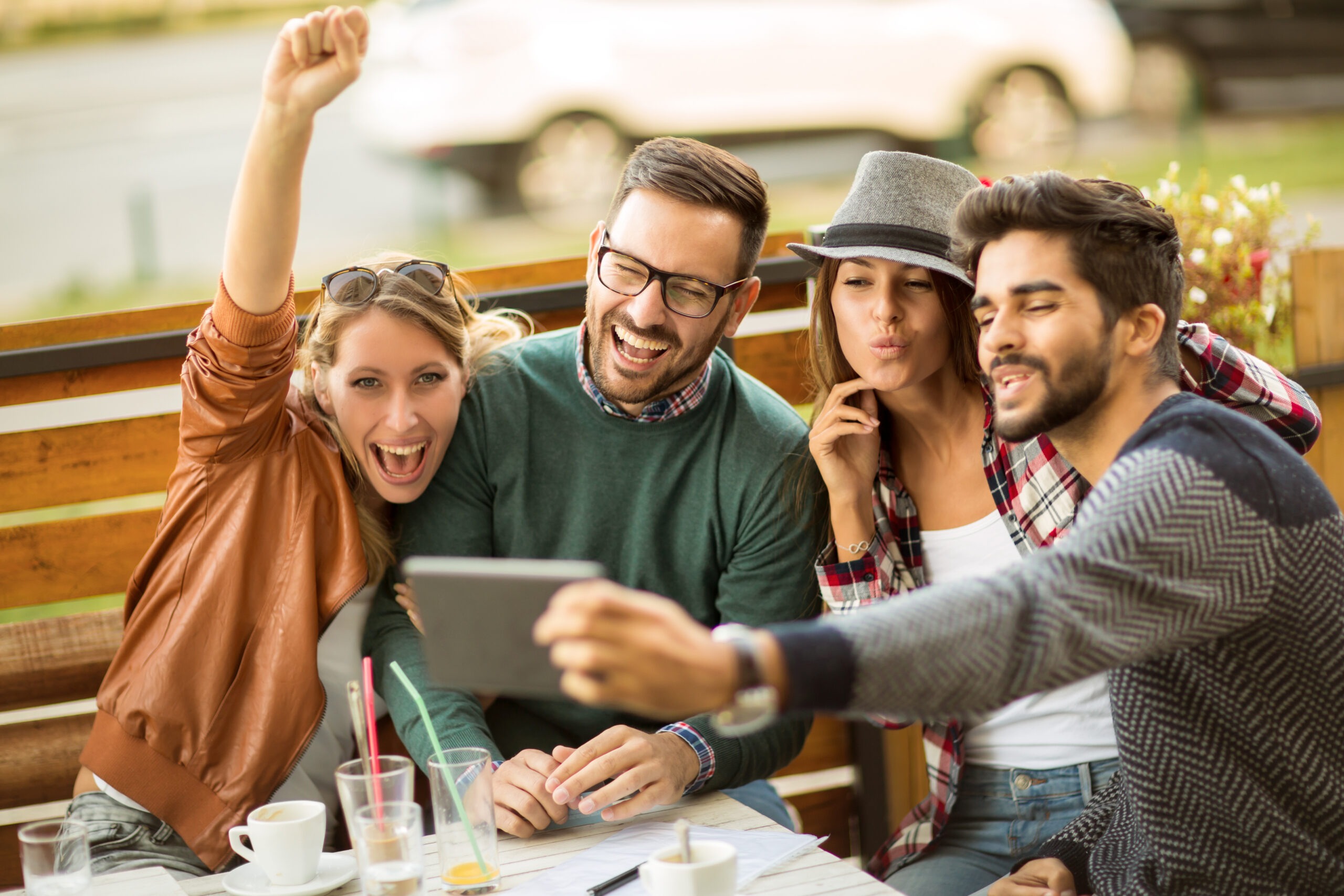 Group of four friends having a coffee together.
